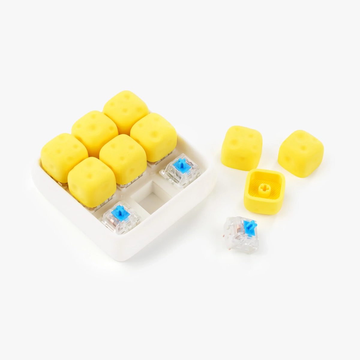 Yellow cheese-shaped mechanical keyboard switch caps and clear switch blanks